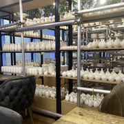 Finished Ceramic Pieces and Interior Seating at Clayful Cafe Orchard Central