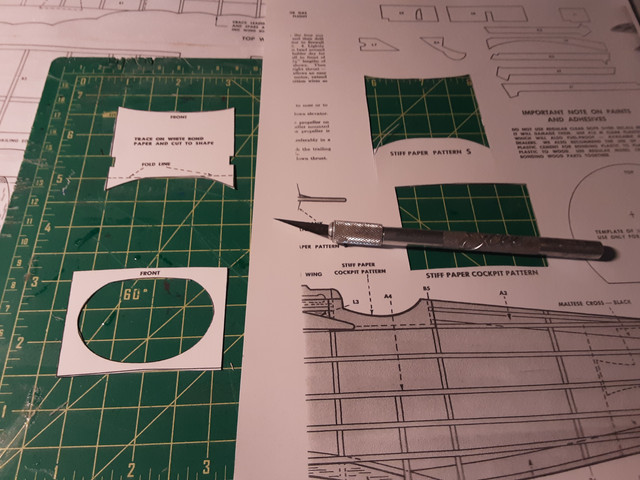 I printed out the parts on stiff paper, cut them out. The cockpit cutout goes on the fuselage before covering it. The other piece goes on after the mid-wings are installed.