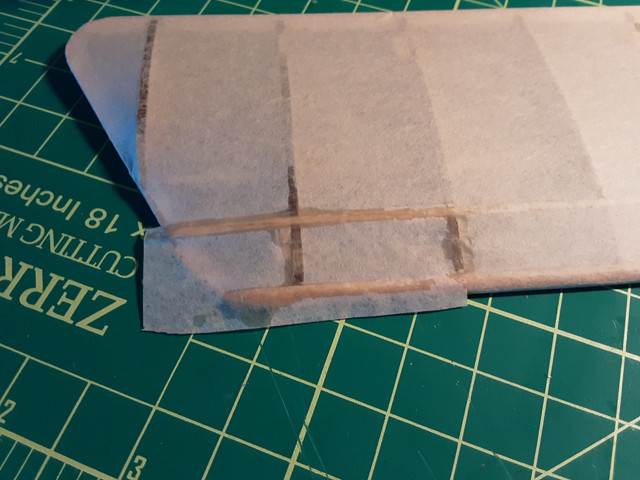 The new patch is in place. Note that I didn't glue down the outside edge. Take your time, glue the tissue down in multiple stages.