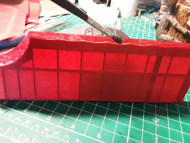 Put the glue on the back edge of the wing. Avoid getting glue on the topside of the trailing edge piece as you don't want the tissue to stick to the piece between the ribs. It's unsightly.