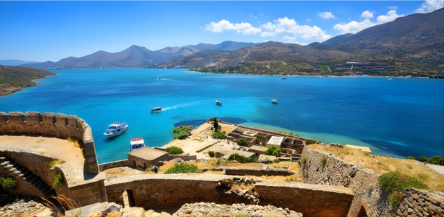 Spinalonga Island viewed from Elounda, Crete, Greece with a boat trip in the Aegean Sea — top attractions and experiences for international visitors and property buyers with Destinations by LeadingRE (2025–26).