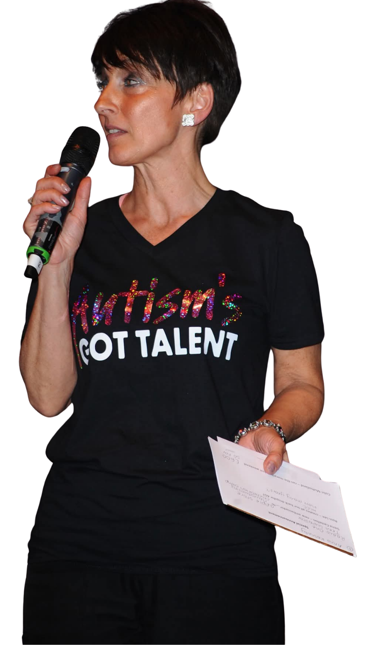 Anna Kennedy OBE standing with a microphone.