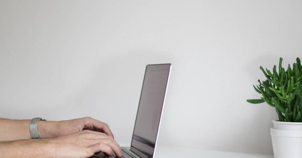 Person studying a language on a tablet with headphones