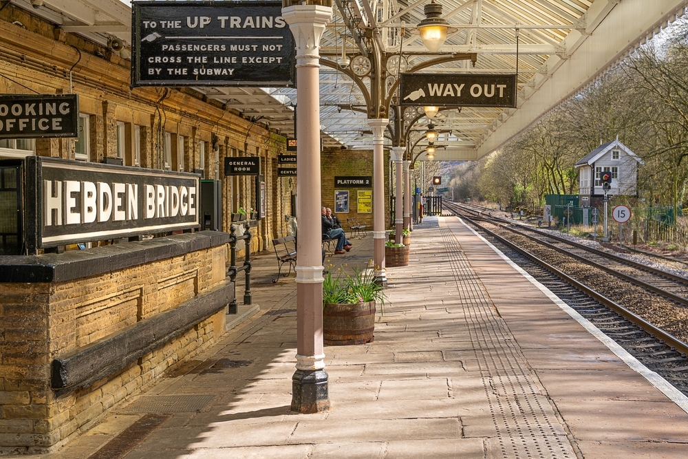 Panoramic view of Hebden Bridge, West Yorkshire, with historic stone houses nestled in the scenic Calder Valley, ideal for international buyers seeking property in a charming English town.