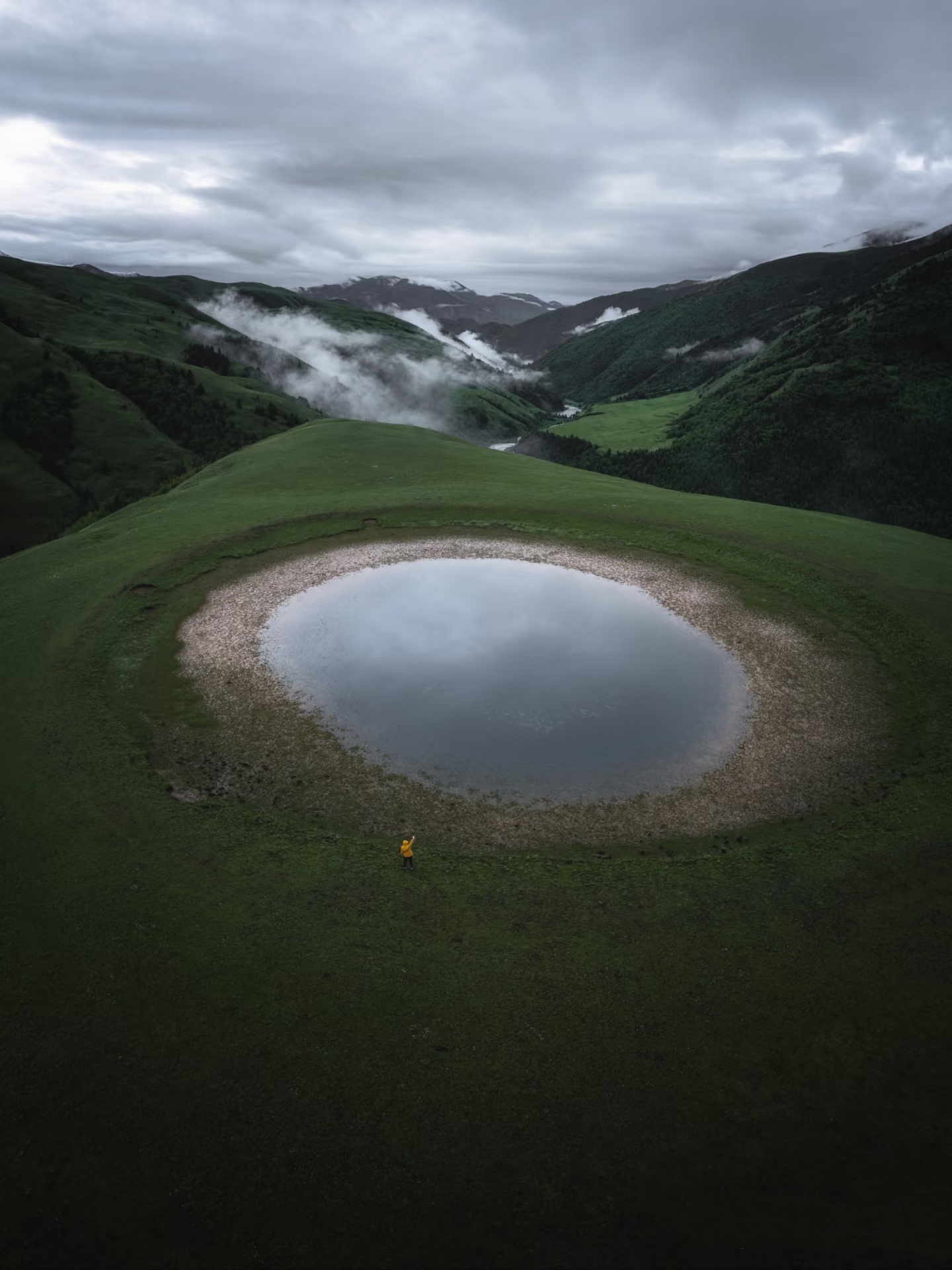 Eye of Genyen — sacred turquoise lake beneath Mount Genyen