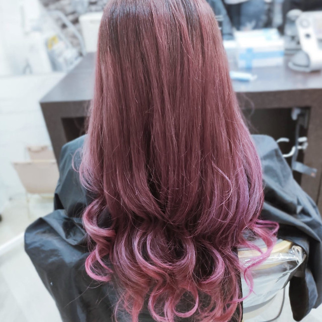 Long layered hair styled in a soft rose-purple colour at Olson Studio