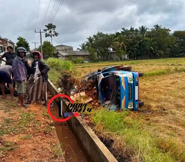 A lorry transporting a batch of coconuts ran off the road and overturned in Shravastipur due to a collision with a bus.
