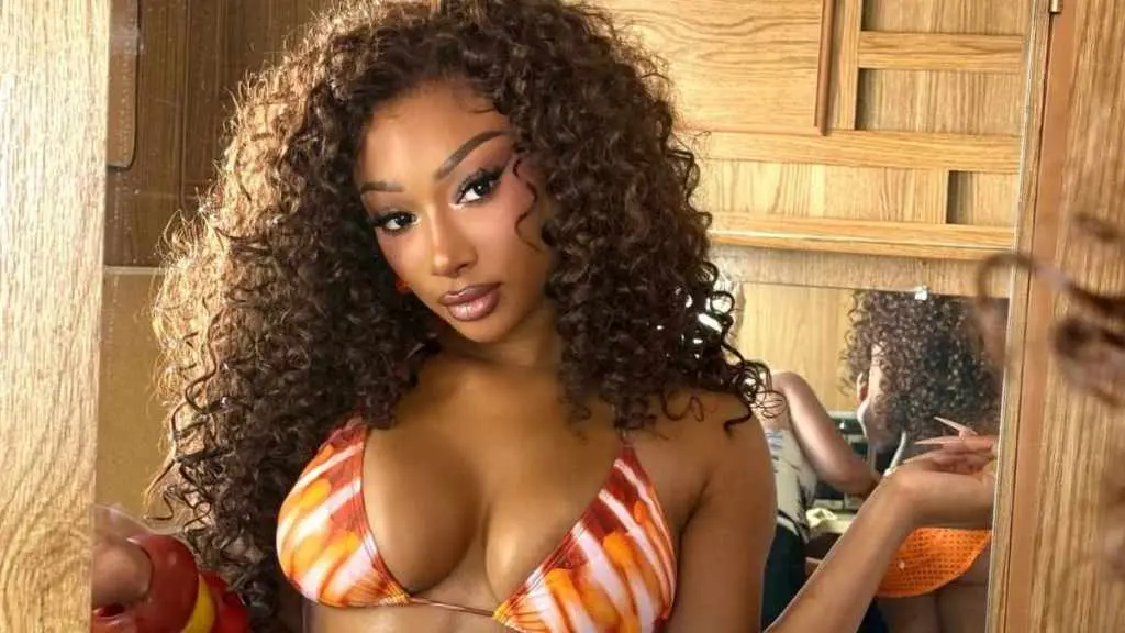 Megan Thee Stallion Dazzles in Sheer Gold for Fragrance Launch