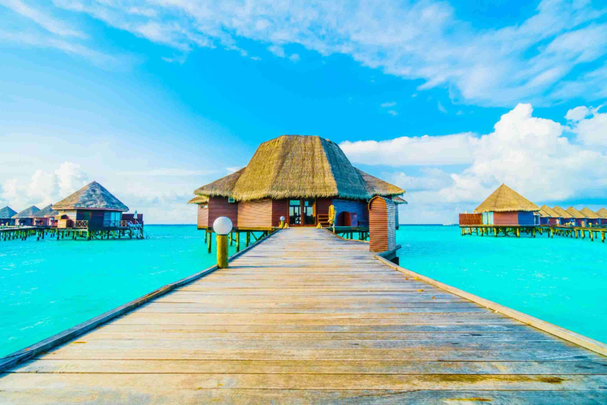 An image showing a serene view of the Maldives Islands with turquoise water and luxurious overwater bungalows.