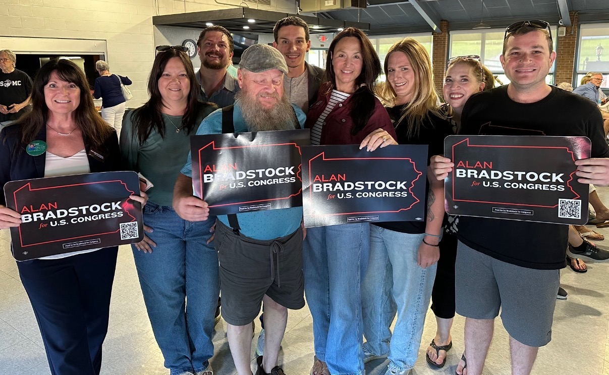 Supporters holding Alan Bradstock for U.S. Congress placards