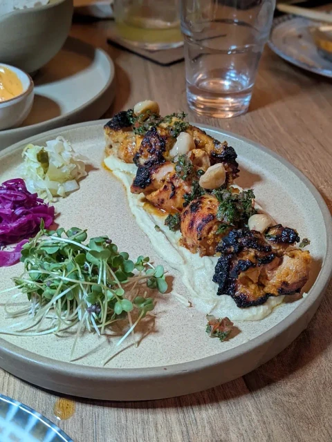 Signature clay oven grilled skewers and hummus at NOBA