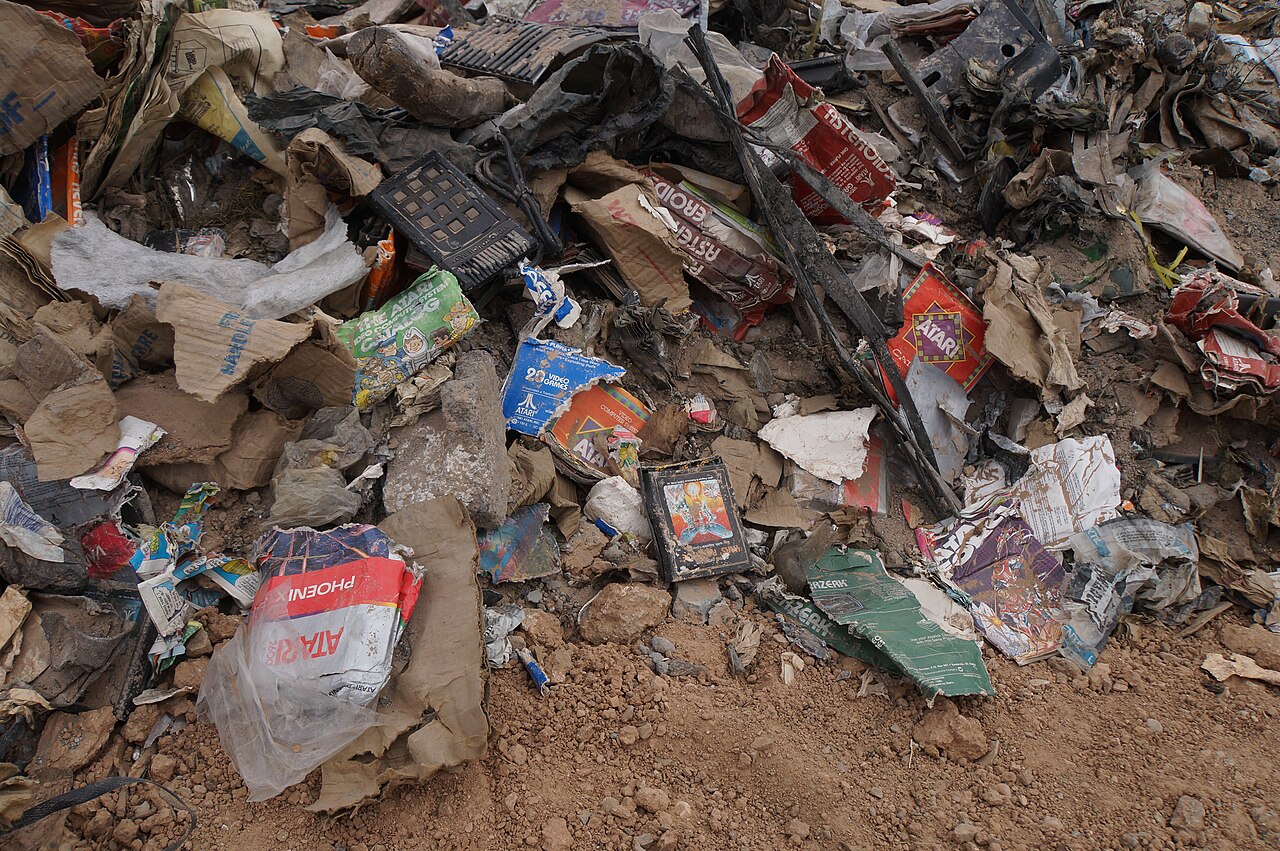 Dusty Atari game cartridges and packaging recovered from the landfill at Alamogordo
