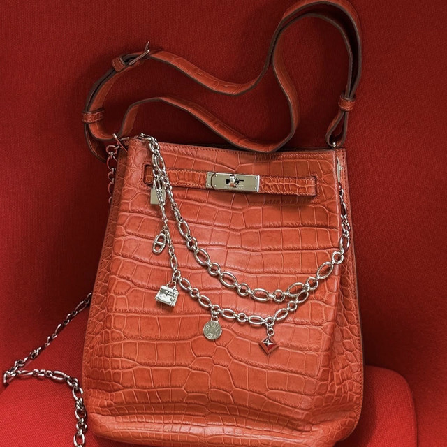 Brown structured handbag with chain and leather shoulder straps