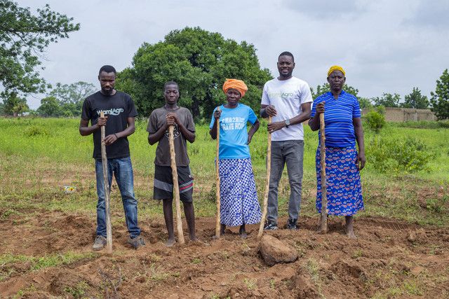 Group of agricultural workers standing in field