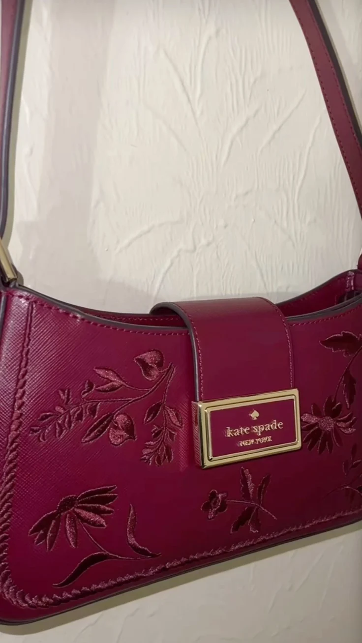 A photo of a Kate Spade burgundy purse.