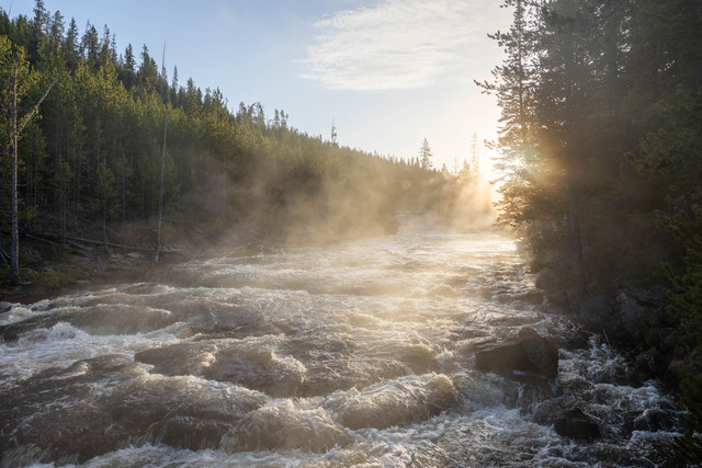 Sunlit Yellowstone river and steam