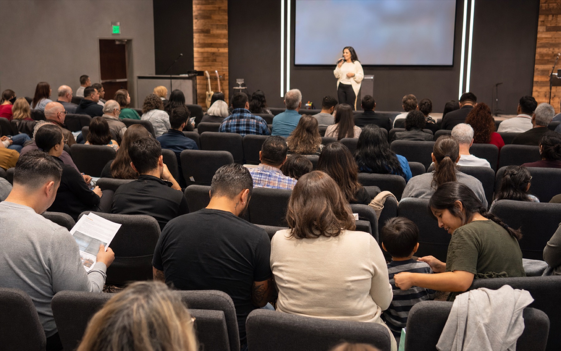Church congregation listening during a stage announcement