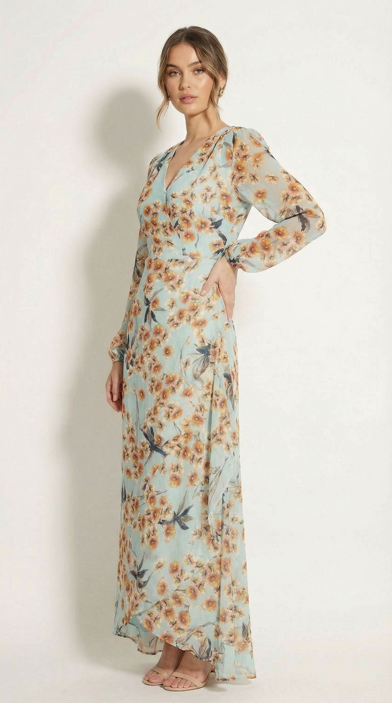 Model posing in a blue floral custom dress