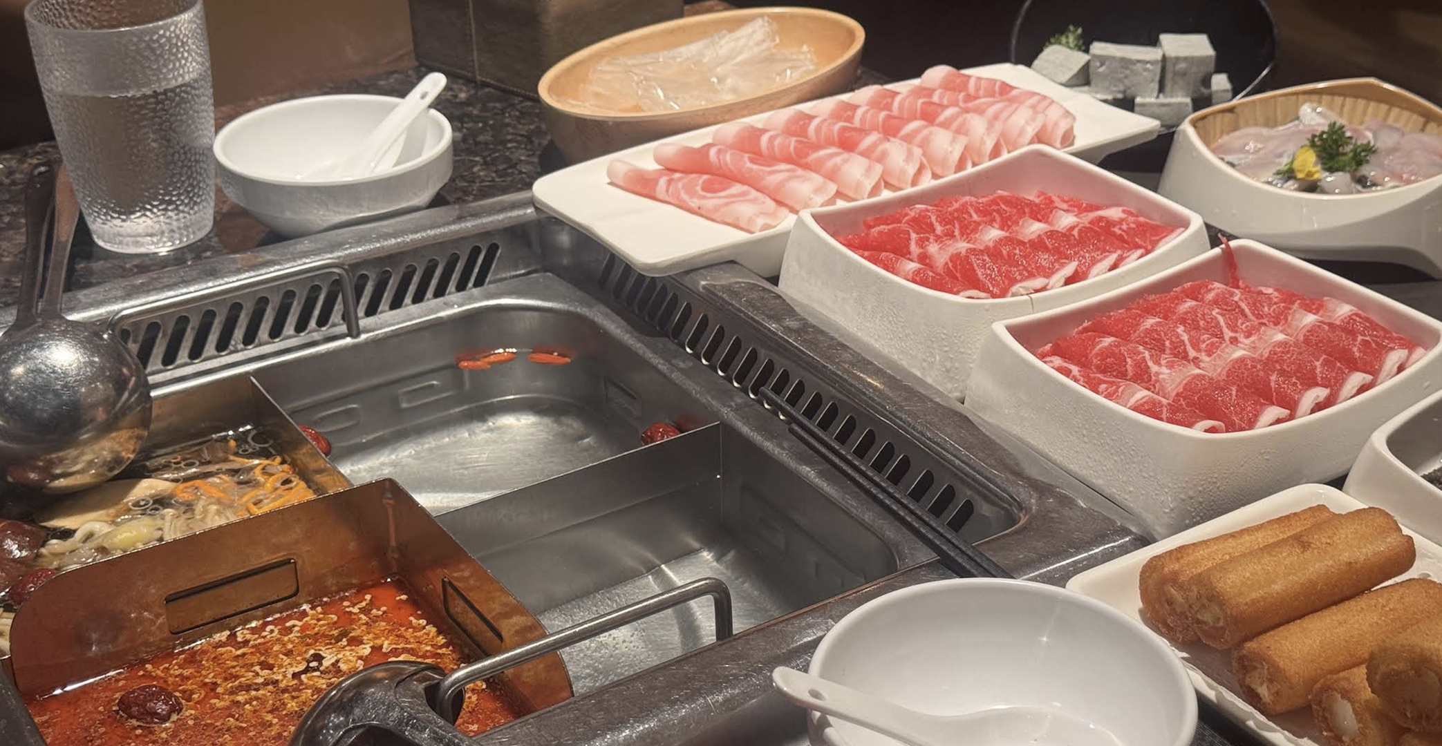 Sichuan hot pot broth and ingredients at Haidilao