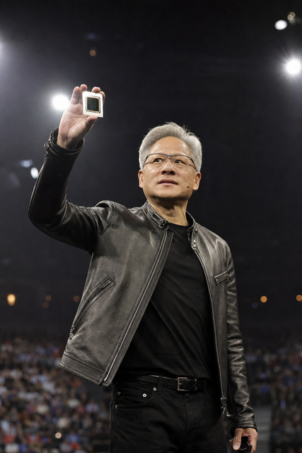 Photorealistic photojournalistic image of a technology chief executive holding a small luminous AI computing chip on stage at a keynote, lar