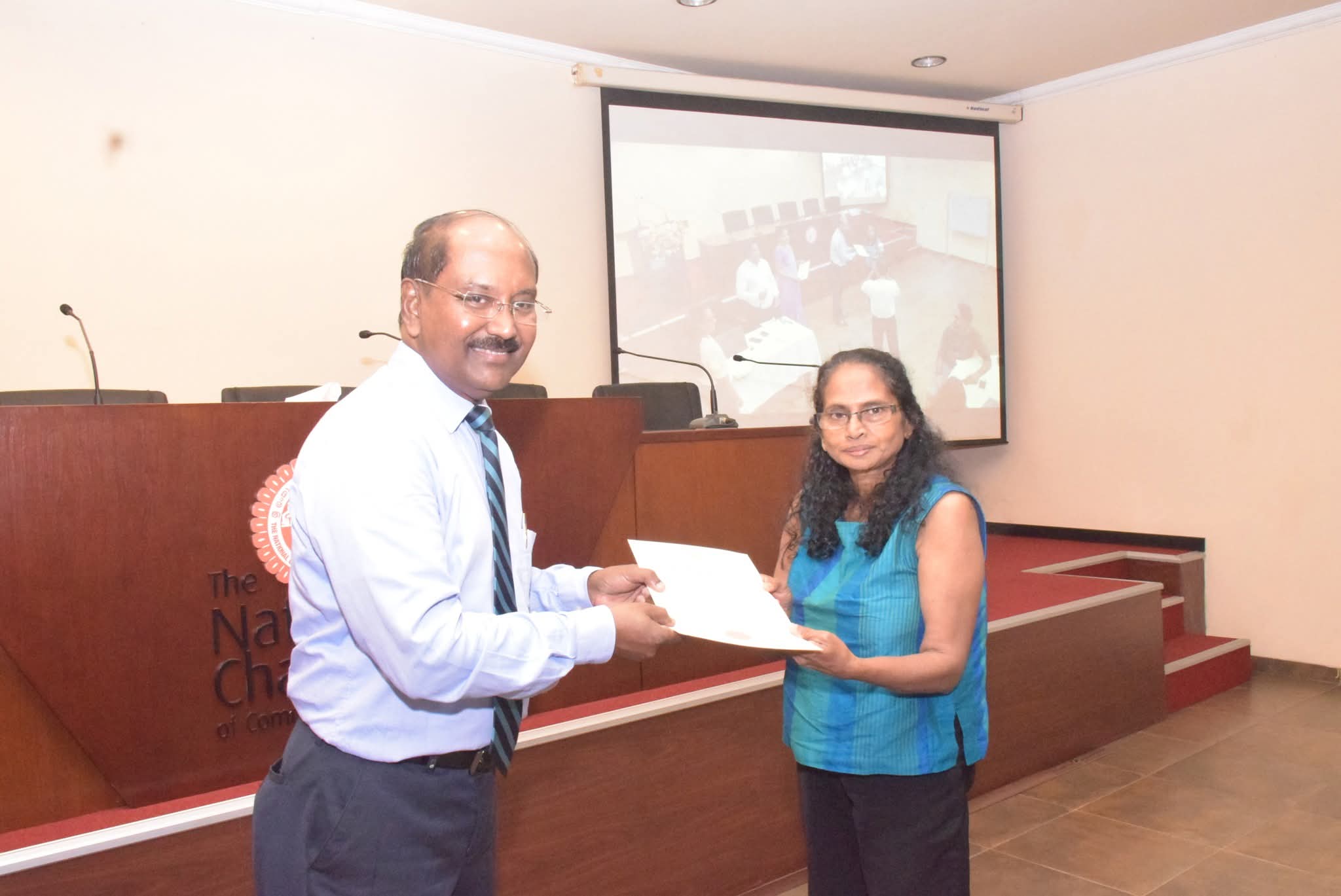 Founder receiving certificate from National Chamber of Commerce