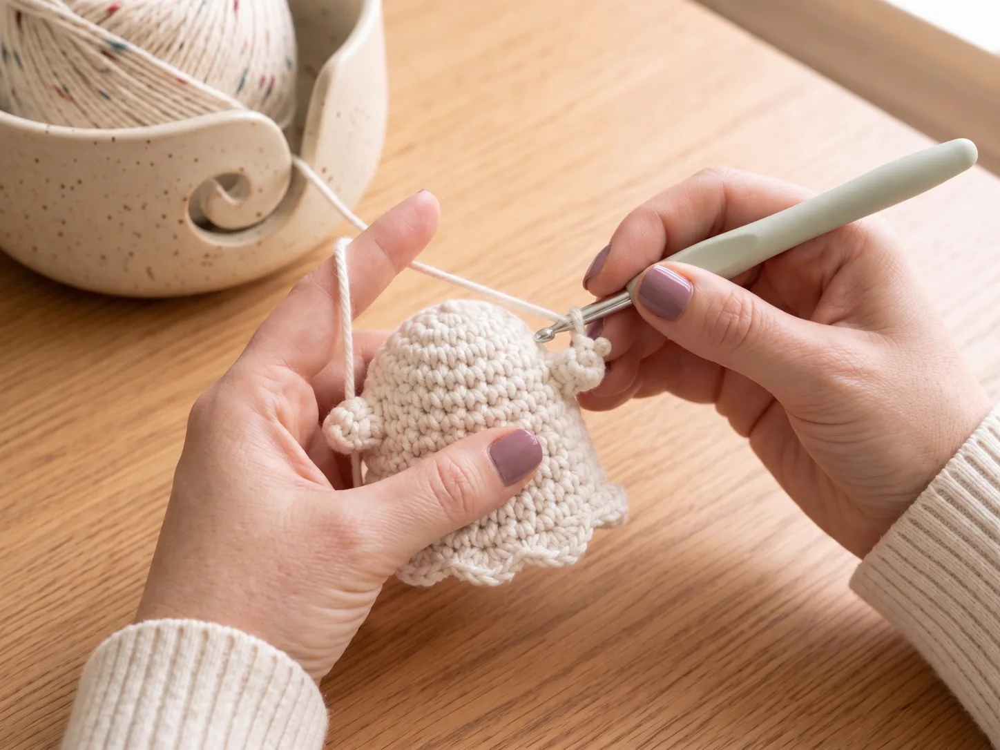 Shape the little arms — Form or attach the two tiny side arms so the ghost already starts to look playful and balanced.