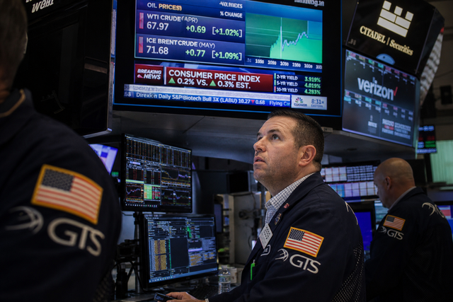 A busy Wall Street trading floor with traders watching monitors displaying economic data, inflation figures and oil prices, financial news d