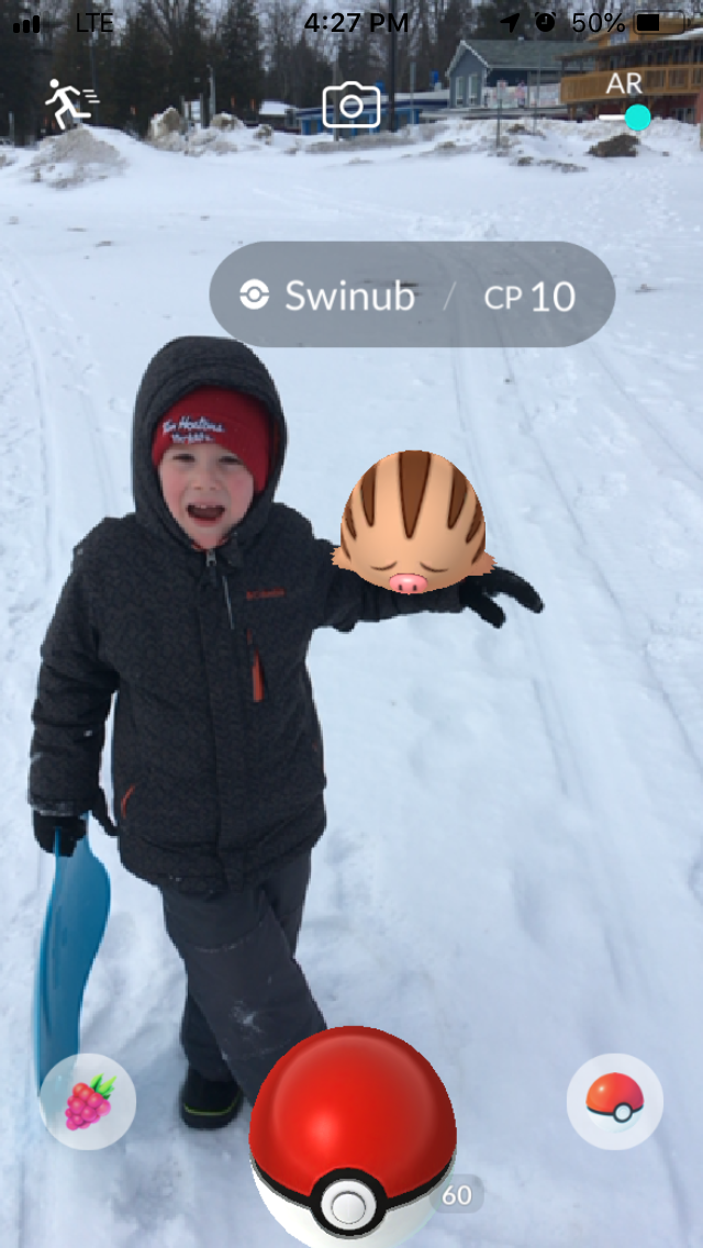 My oldest kid in a snowy environment with a Swinub perched on his arm