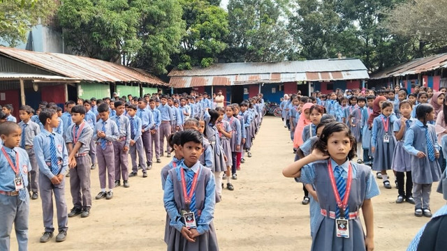 The main academic block and lawn at Goalpokher Pioneer Children's Academy