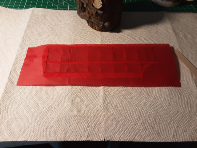 Gently stretch out the tissue and place it on the wing. Move it someplace safe to dry.