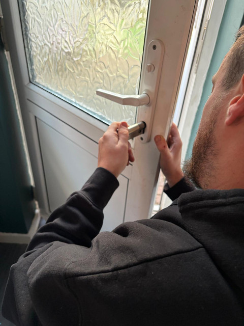 Locksmith replacing a cylinder