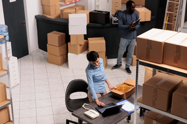 Professional loaders relocating furniture and desktop IT equipment for corporate office move in Manchester