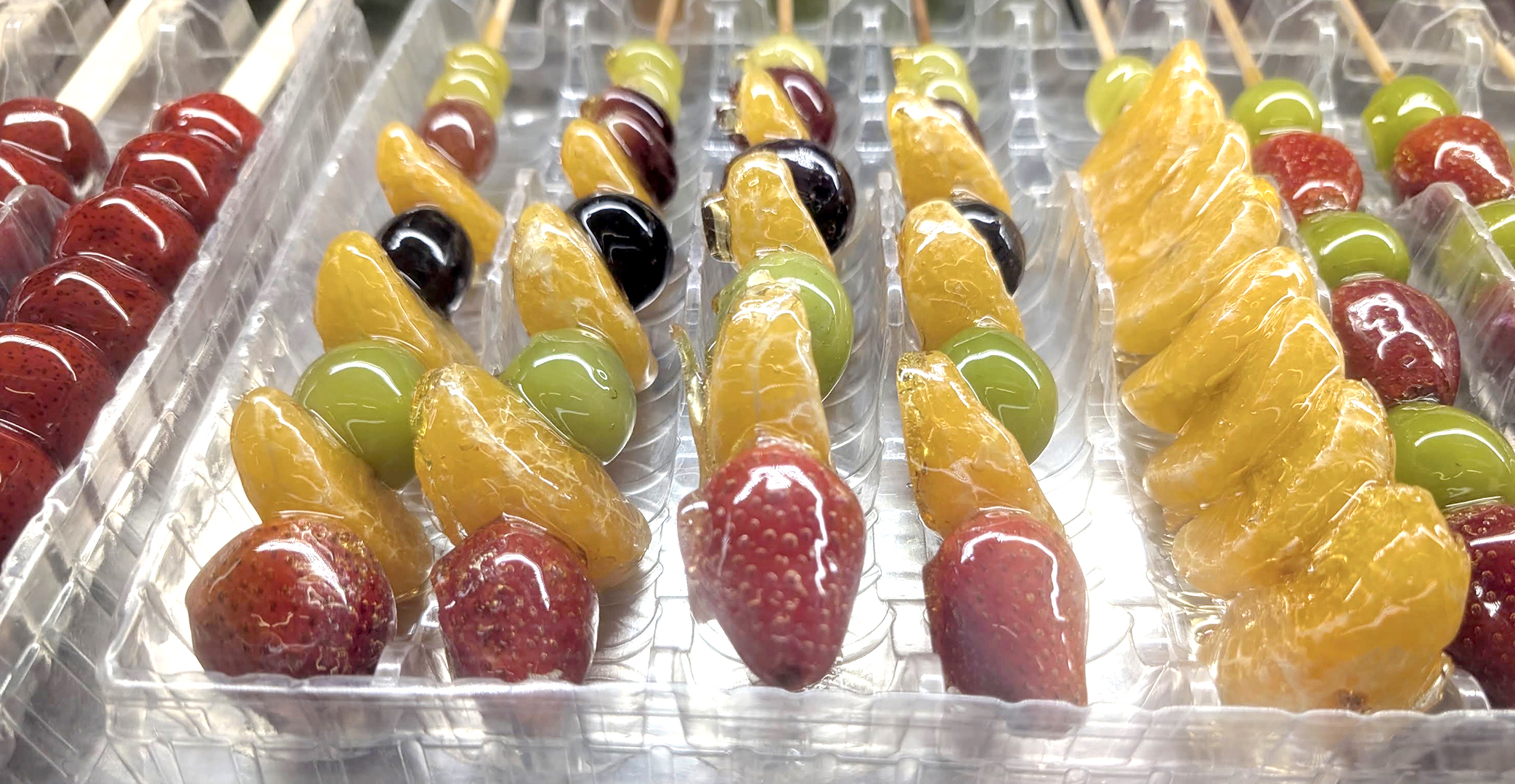 Assorted tanghulu candied fruit skewers at Kang Ji