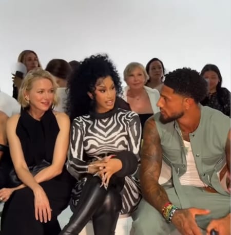 Super Eagles star Maduka Okoye assisting Cardi B to her seat during the Jean Paul Gaultier show in Paris.