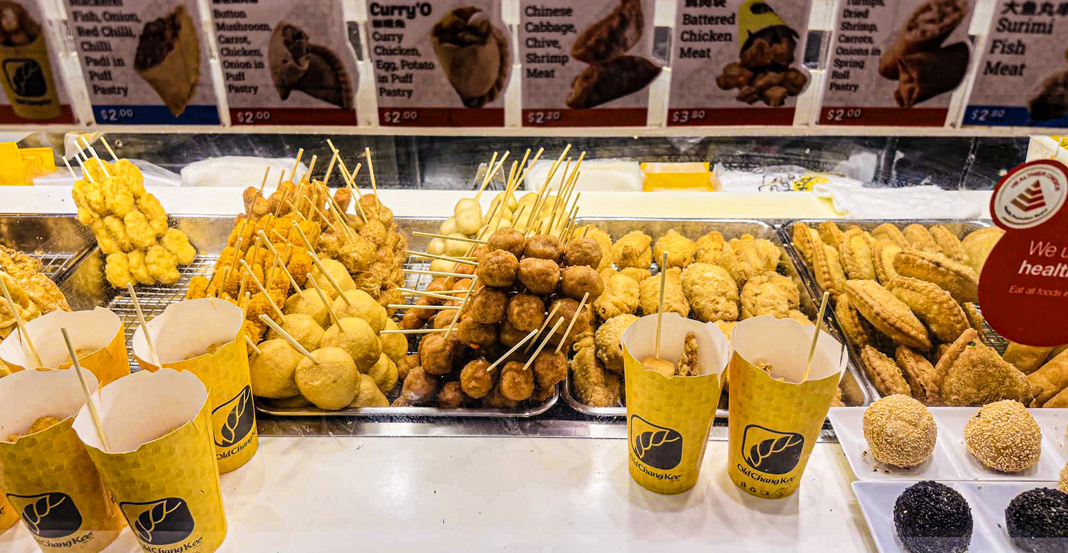 Old Chang Kee full snack counter display with variety of hot snacks and OnStiks