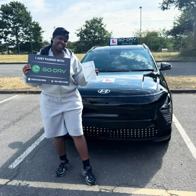 GO-DRV student Shan E. smiling with pass certificate after passing automatic driving test in Featherstone