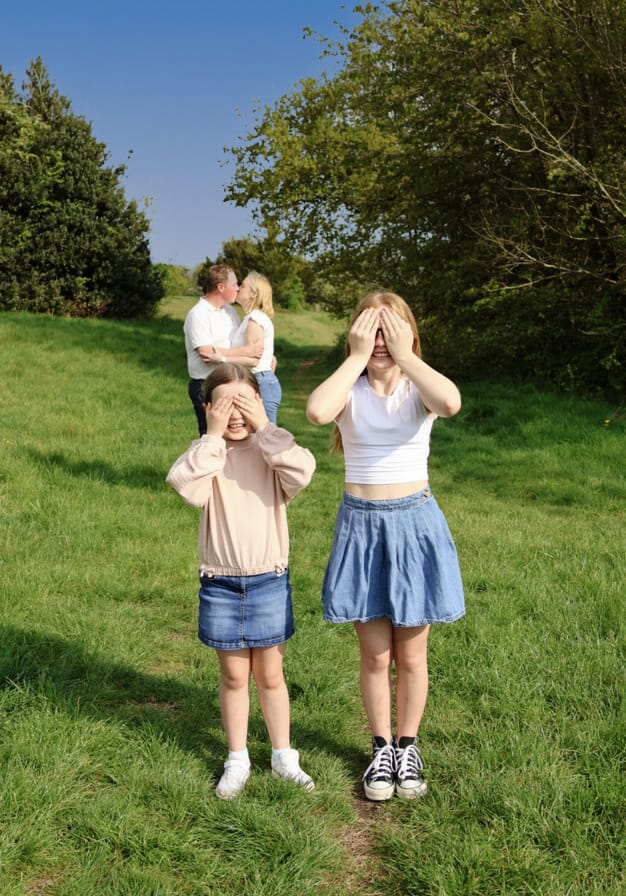 Intimate family moment with children covering eyes