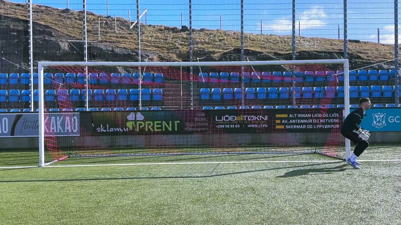 Goalkeeper crossing one leg over the other to move quickly across his goal