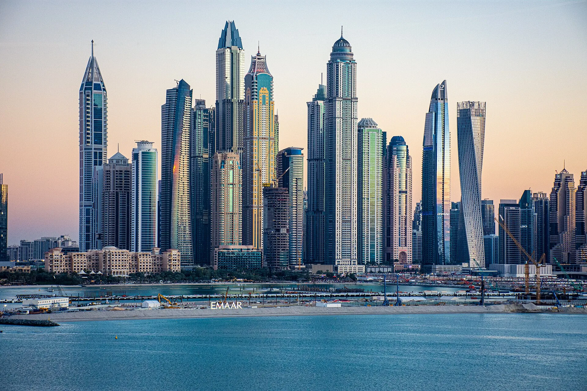 Dubai Marina towers at sunset seen across the water