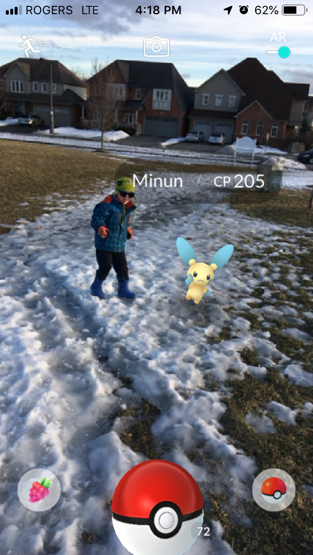 One of my kids with a Minun in our old neighbourhood