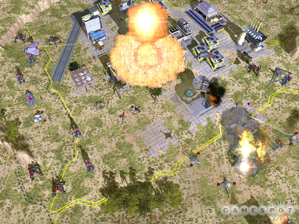 Late-era Empire Earth II base with advanced buildings and a large explosion.