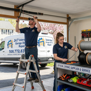 Garage door spring repair technician at work Uxbridge MA