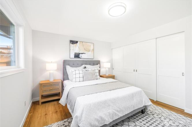 Custom master bedroom with hardwood flooring