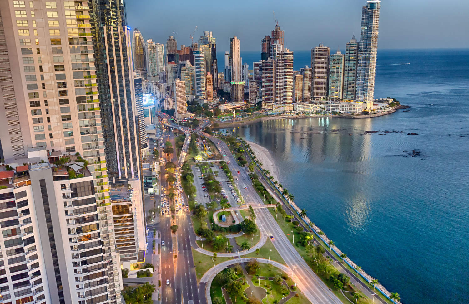 Panama City waterfront skyline and Pacific coastline at dusk