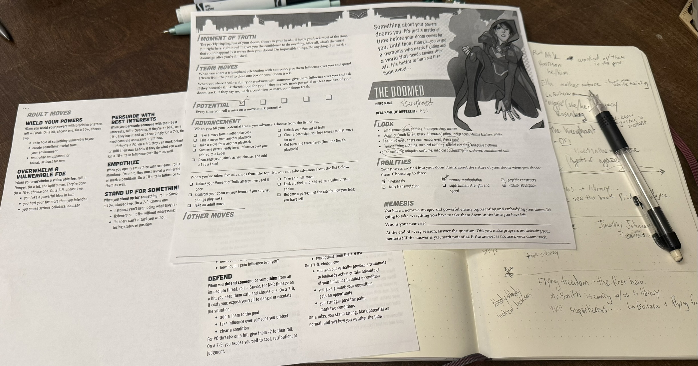The Doomed playbook for *Masks*, Moves sheet and a notebook with notes from the game