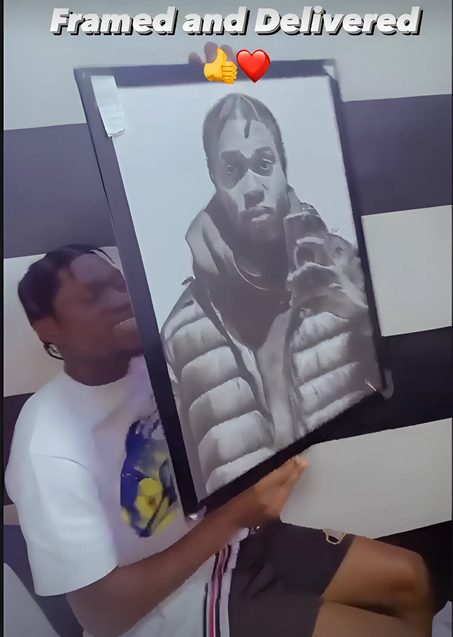 Client posing with a handmade pencil portrait