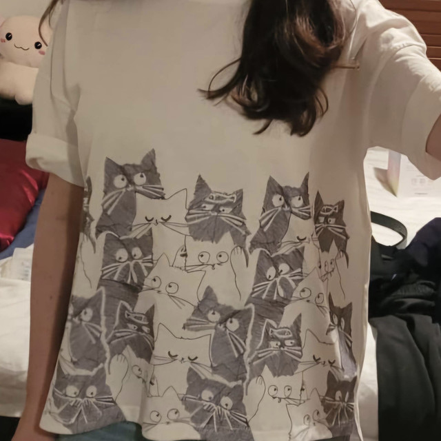 Casual white T-shirt featuring a playful all-over cat illustration