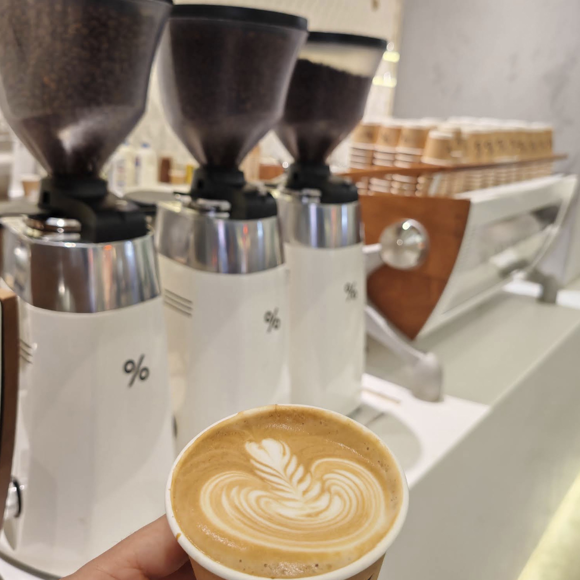 Coffee beans and pastries display at % Arabica