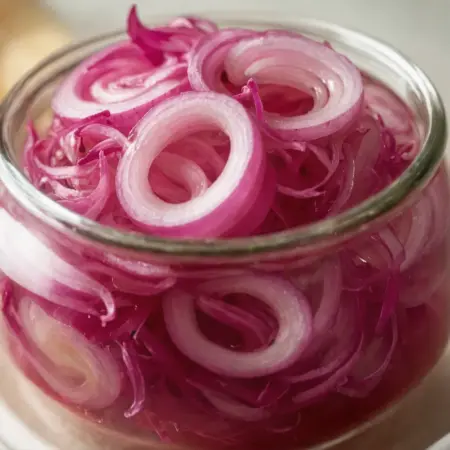 Pack sliced onions into a jar for fresh flavor.