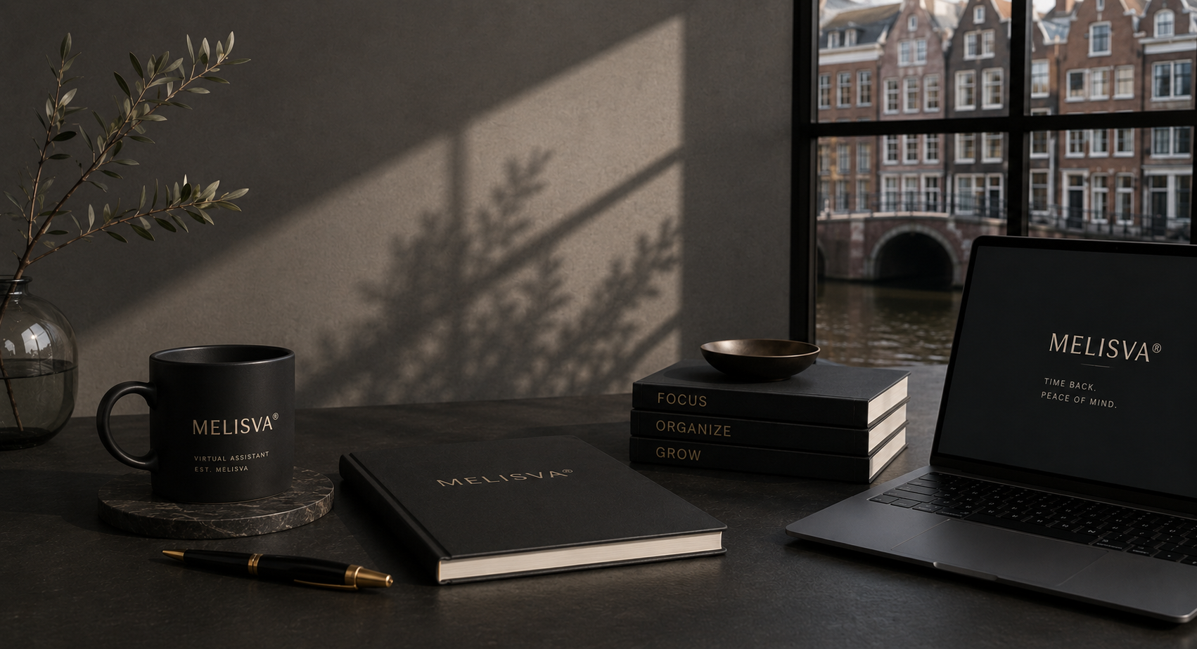 Melisva desk setup with notebook, mug and laptop overlooking an Amsterdam canal